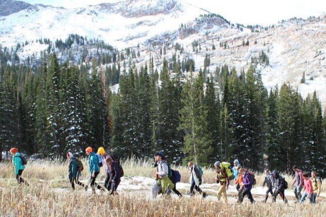 students hiking near trees