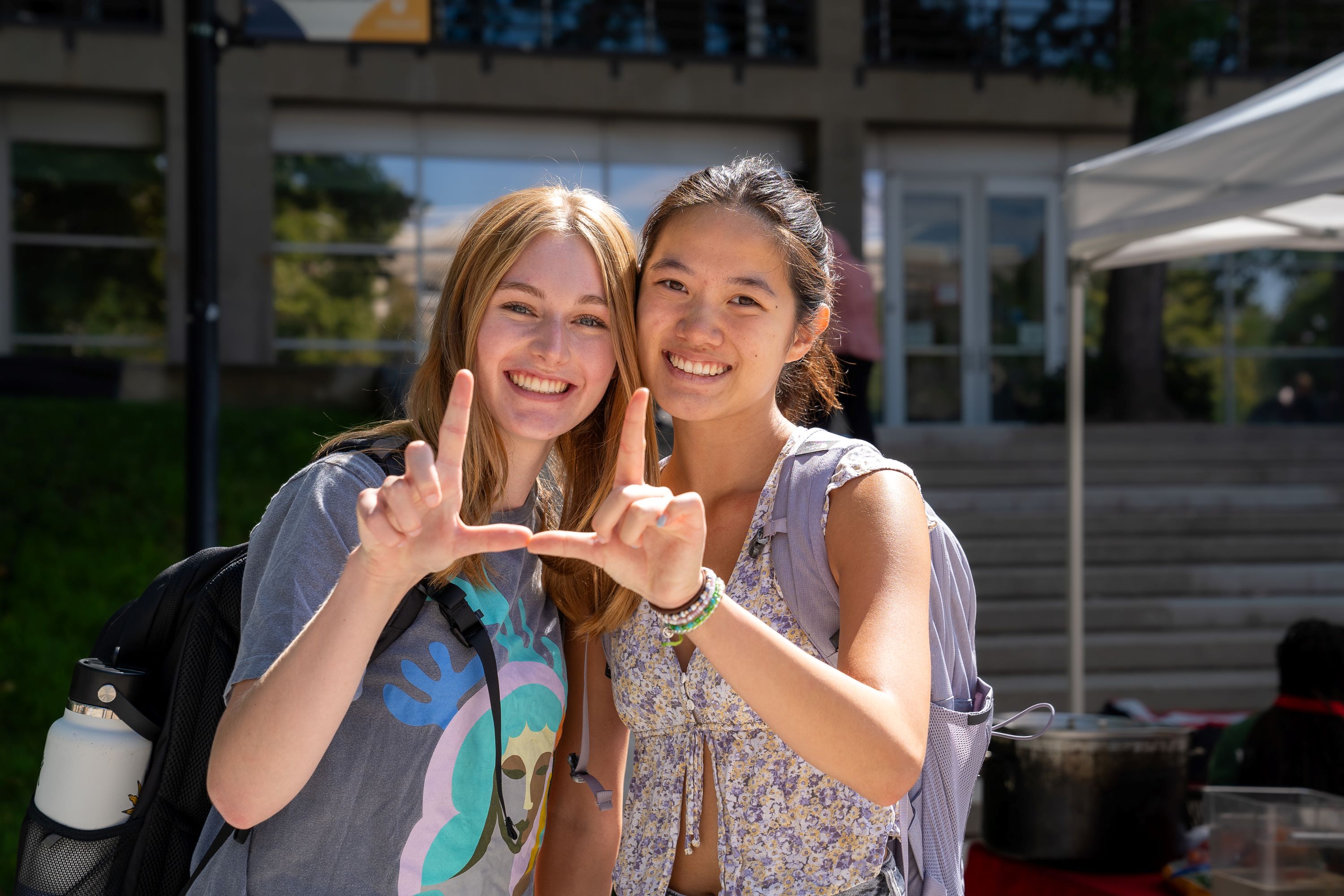 two students making a 'U' shape with thier hands