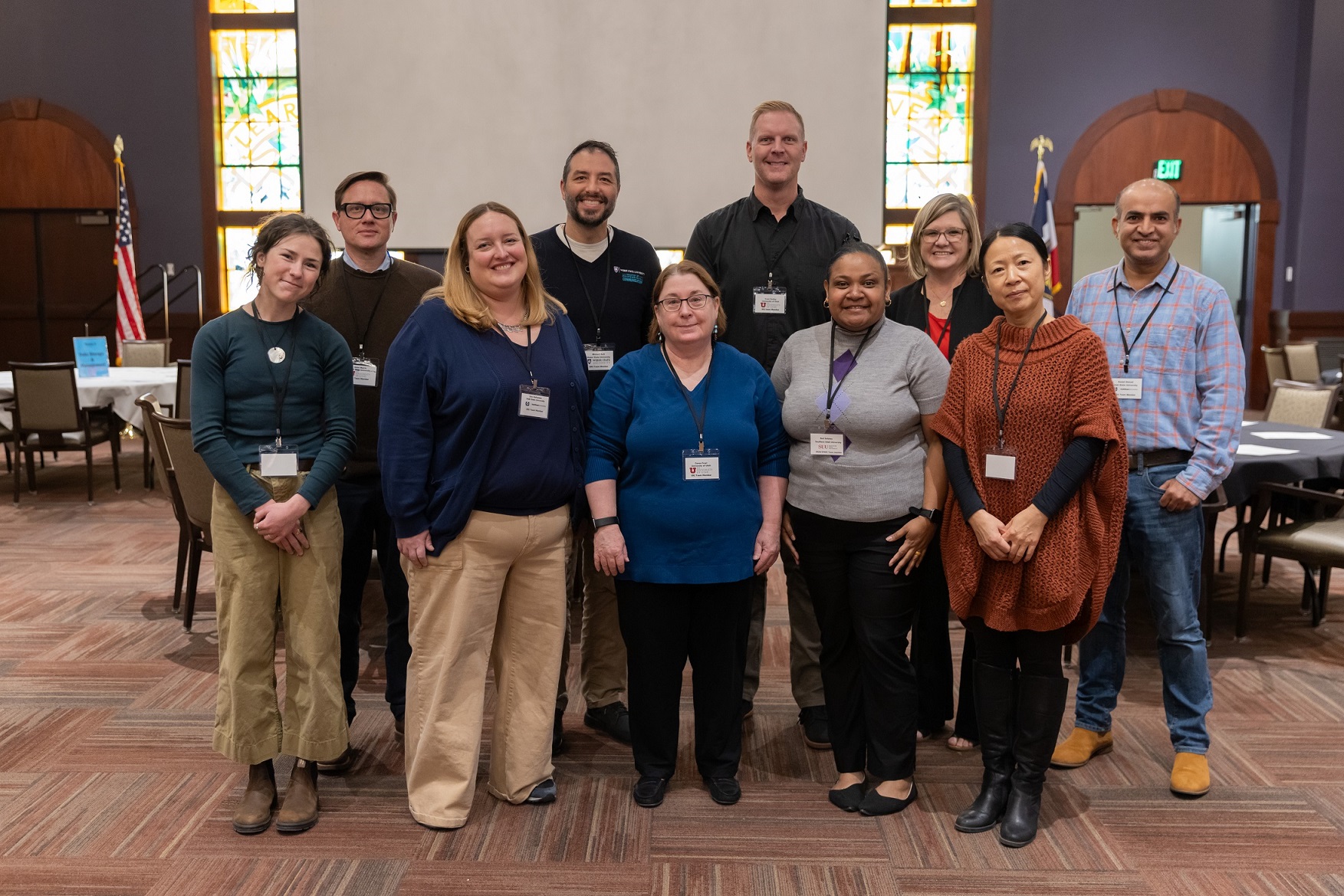 Research group standing in two rows in classroom
